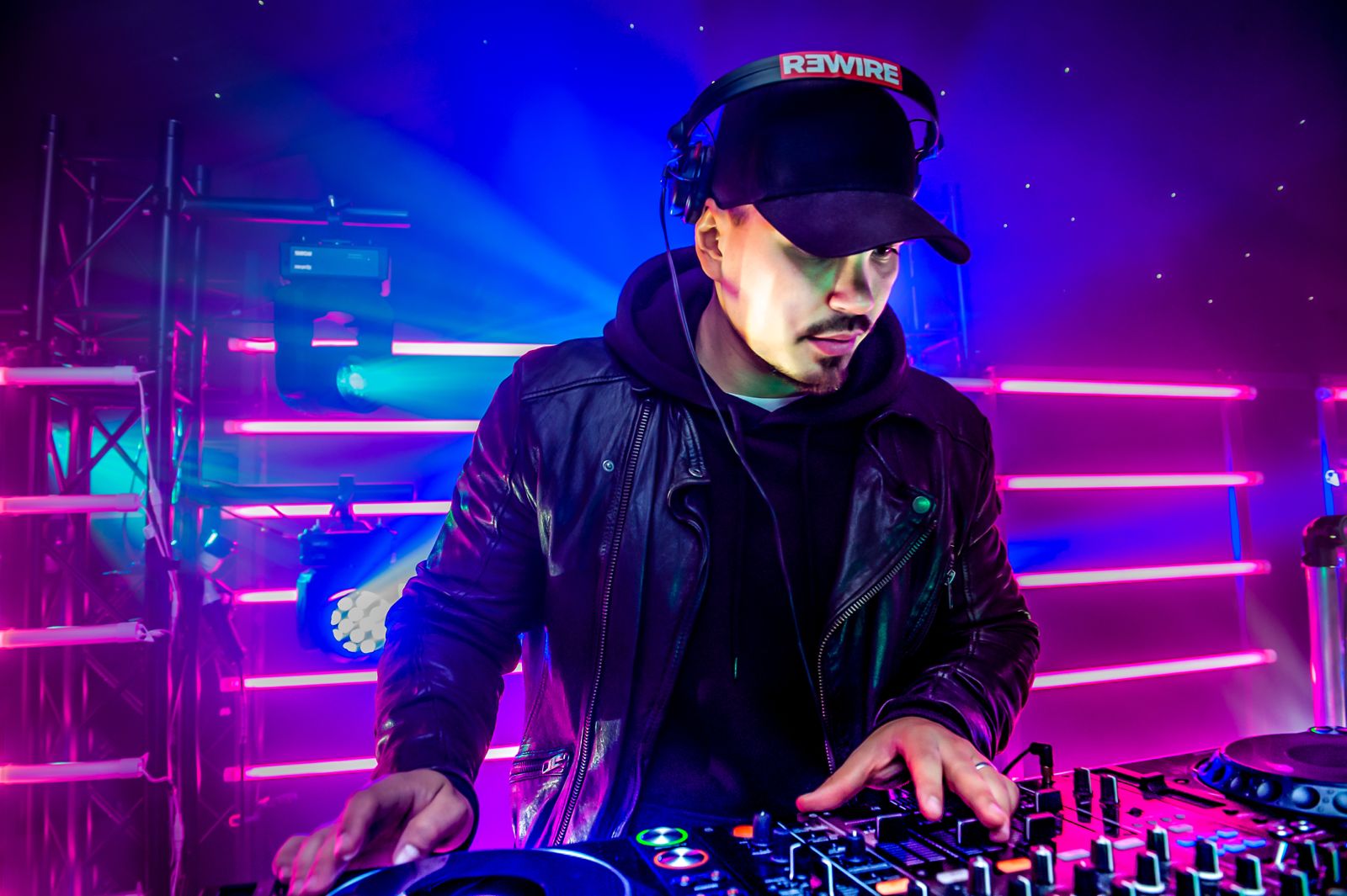 DJ performing under neon lights at a private celebration