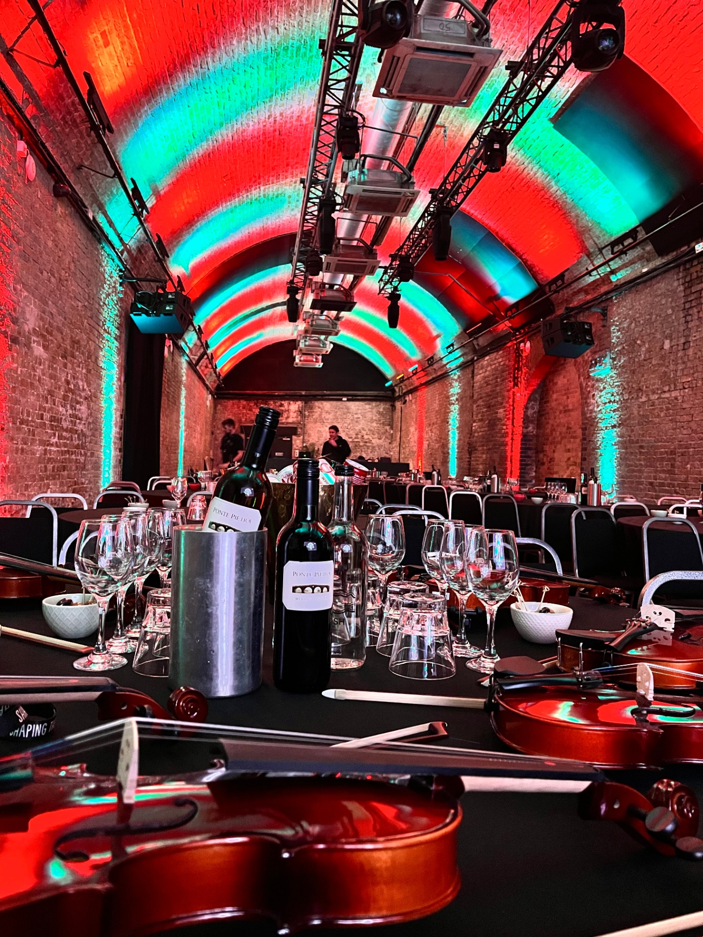 Vaulted venue lit for a corporate dinner
