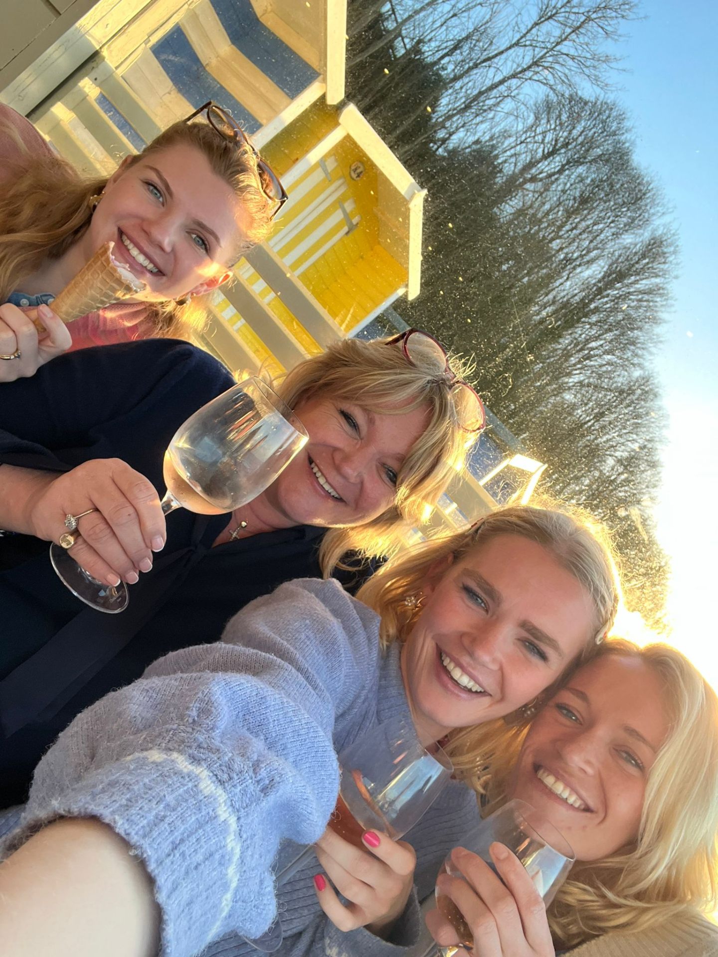 Charlie with friends raising glasses in the sunshine